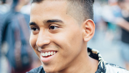 Hispanic teenage boy smiling.