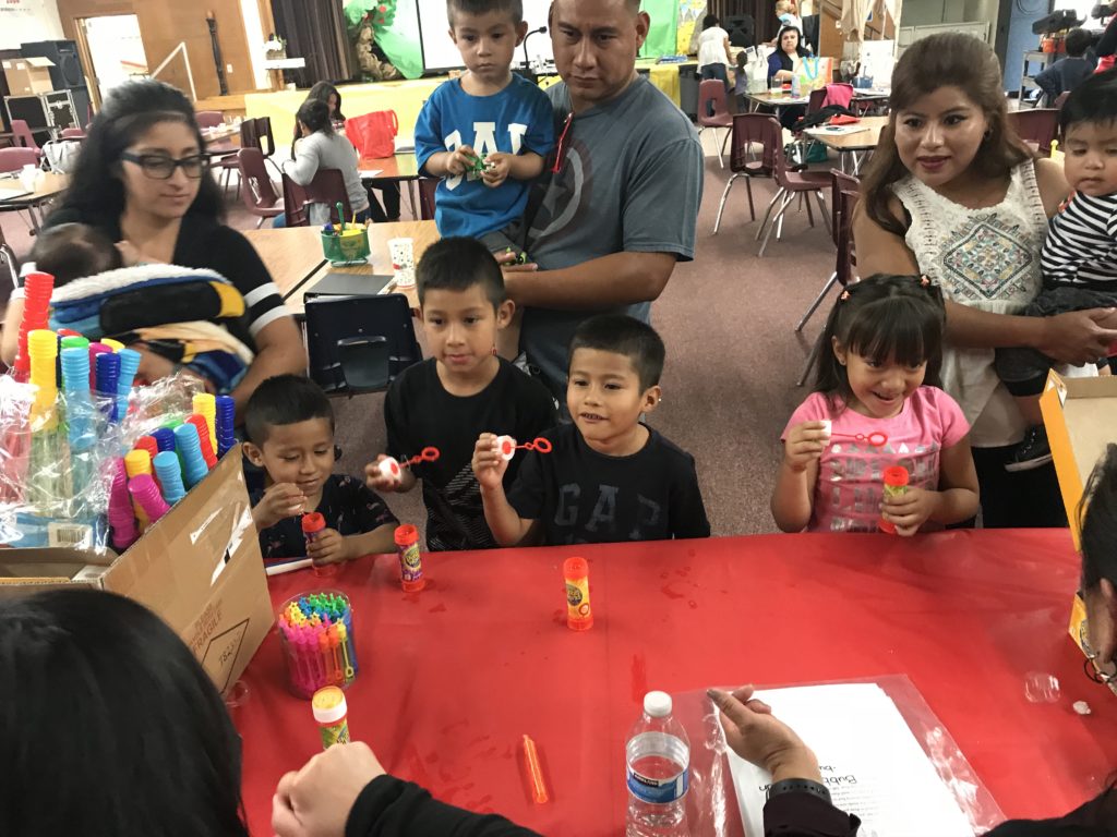 Children blowing bubbles at Santa Ana Early Learning Initiative.