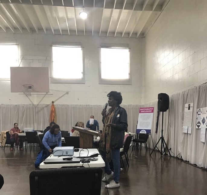 Person speaking at Compton meeting.