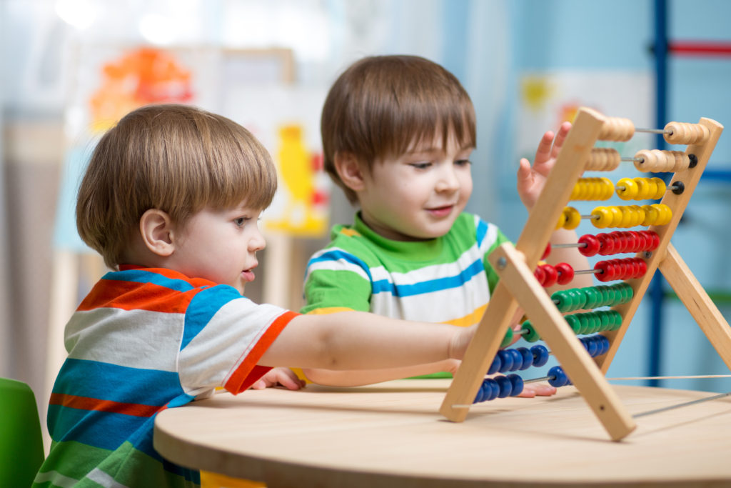 Children playing with abacus toy.