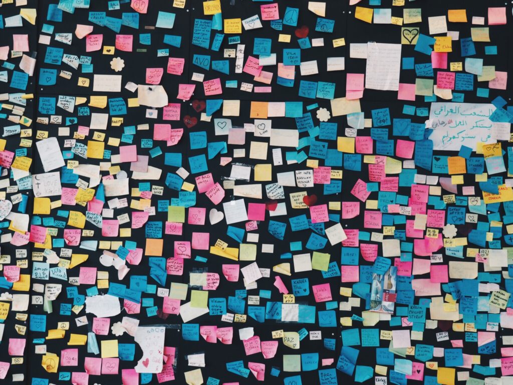Hundreds of sticky notes on a wall.