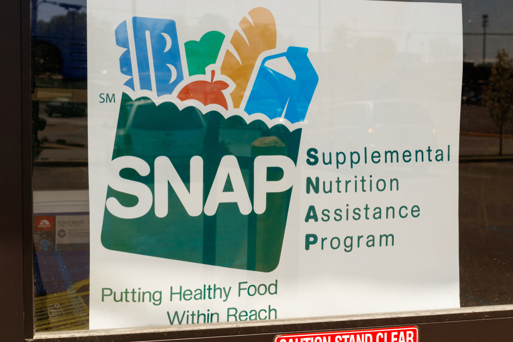 SNAP sign in a storefront window.