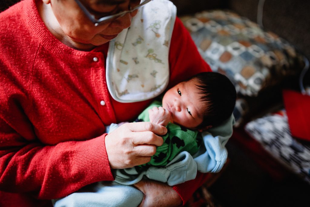 Grandmother and newborn grandson bonding and spending quality time together.