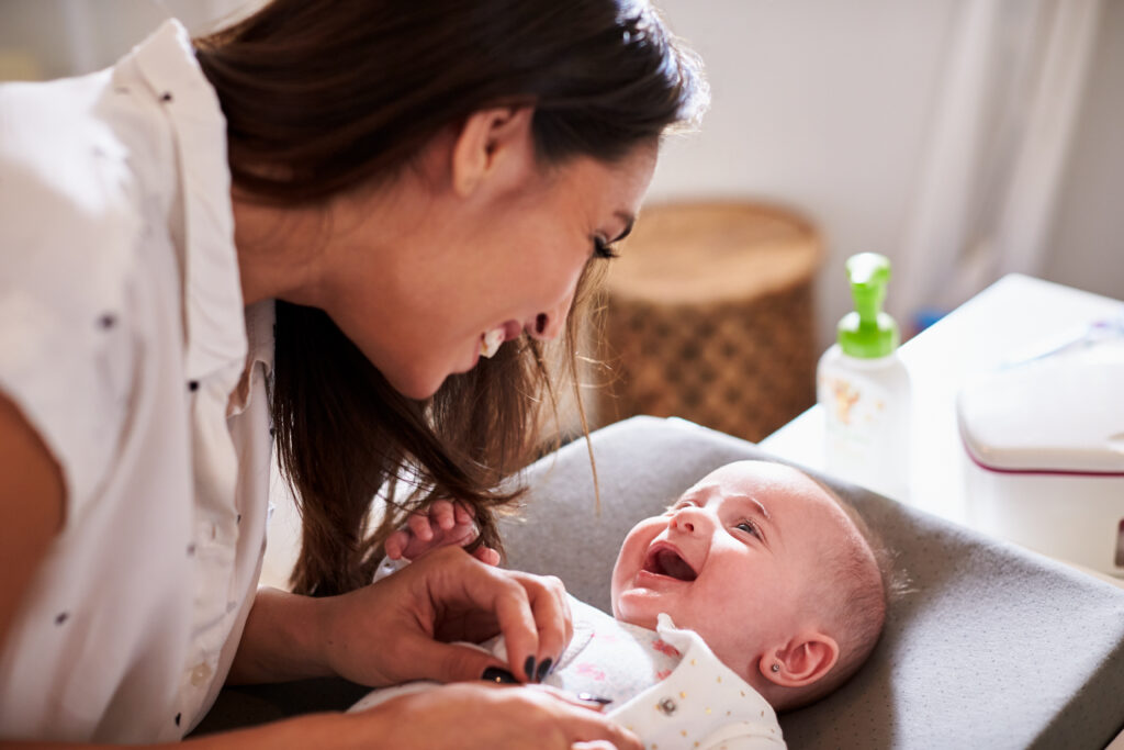 Happy,four,month,old,baby,boy,lying,on,changing,table