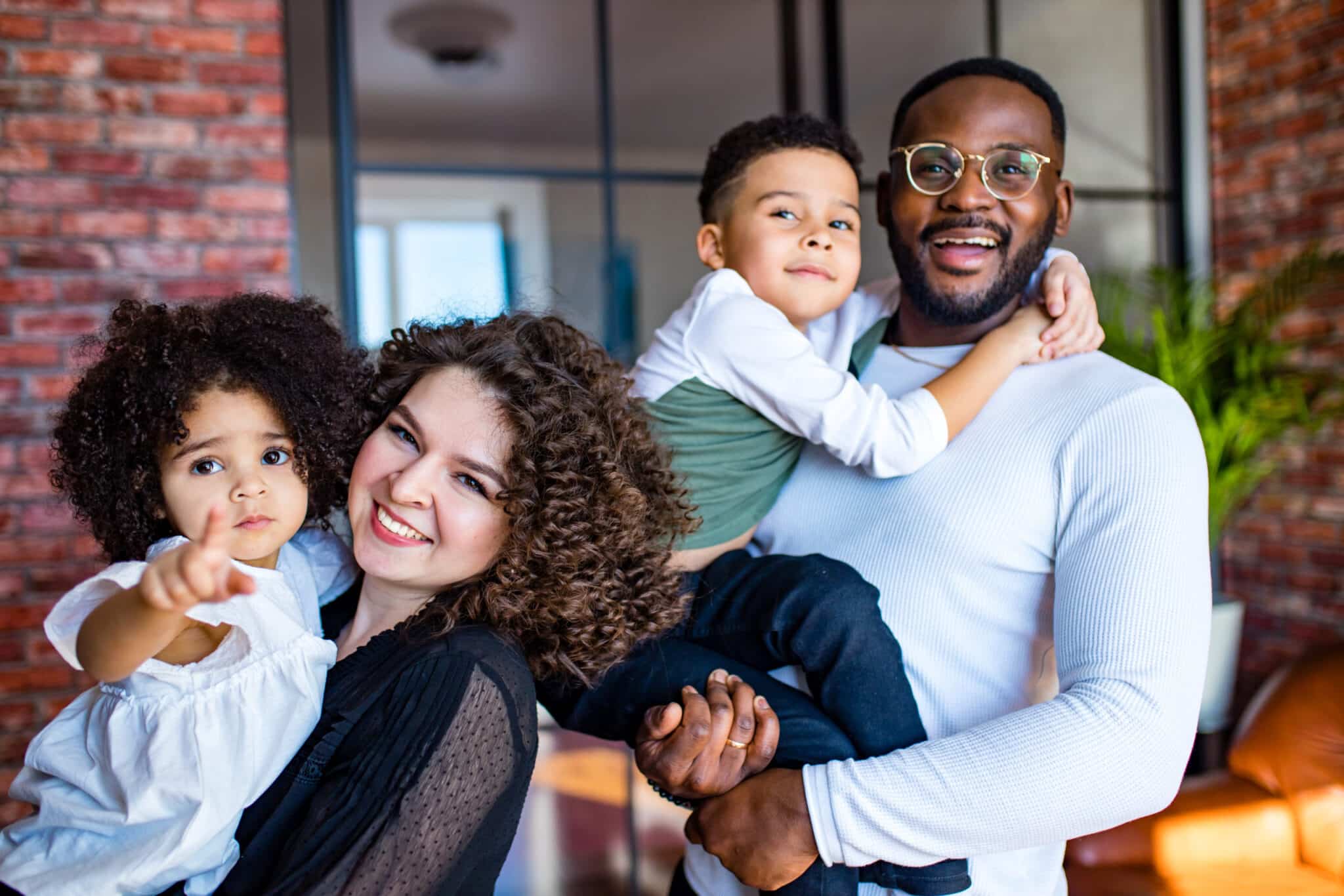 Afro,American,Mixed-raced,Family,Looking,At,Camera,In,Cozy,Summer