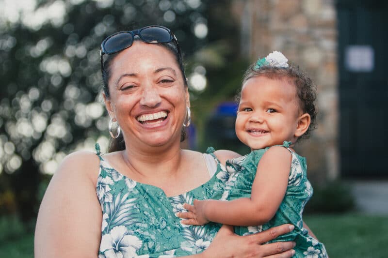 Care and Caregiving mixed-interracial-african-american-family-a-happy-and-smiling-at-an-outdoor-party
