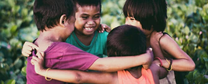 Children hugging in a circle.