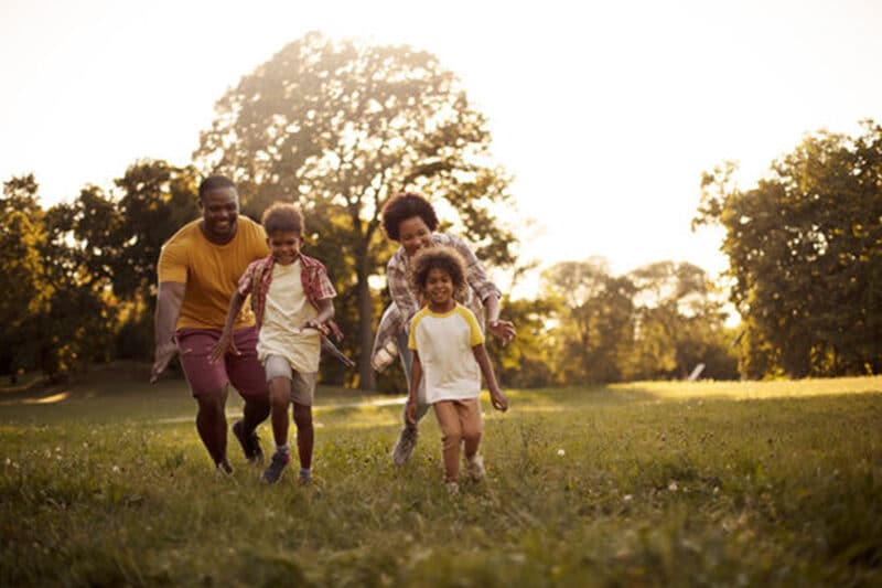 Family Supports and Prevention African American family having fun outdoors.