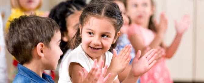 Preschool children clapping.
