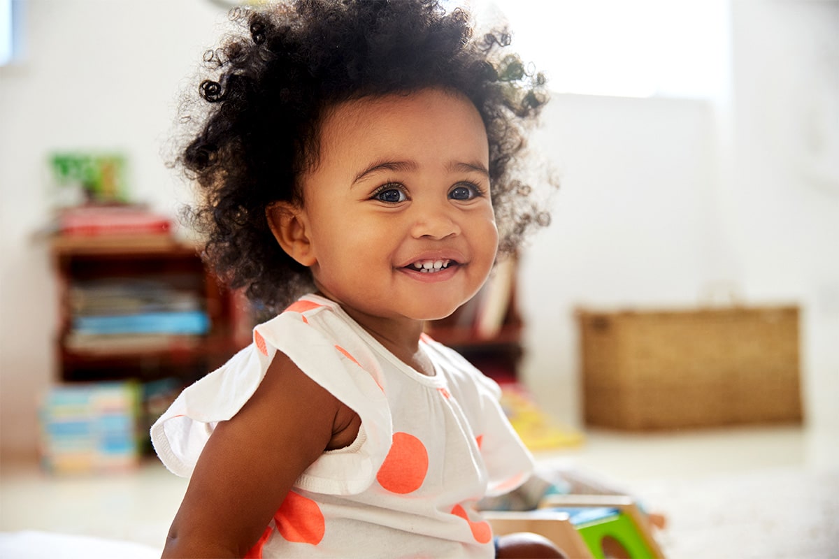 Toddler girl smiling.