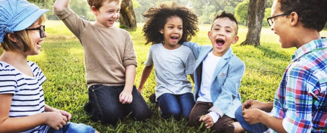 Children are playing on the grass in the park