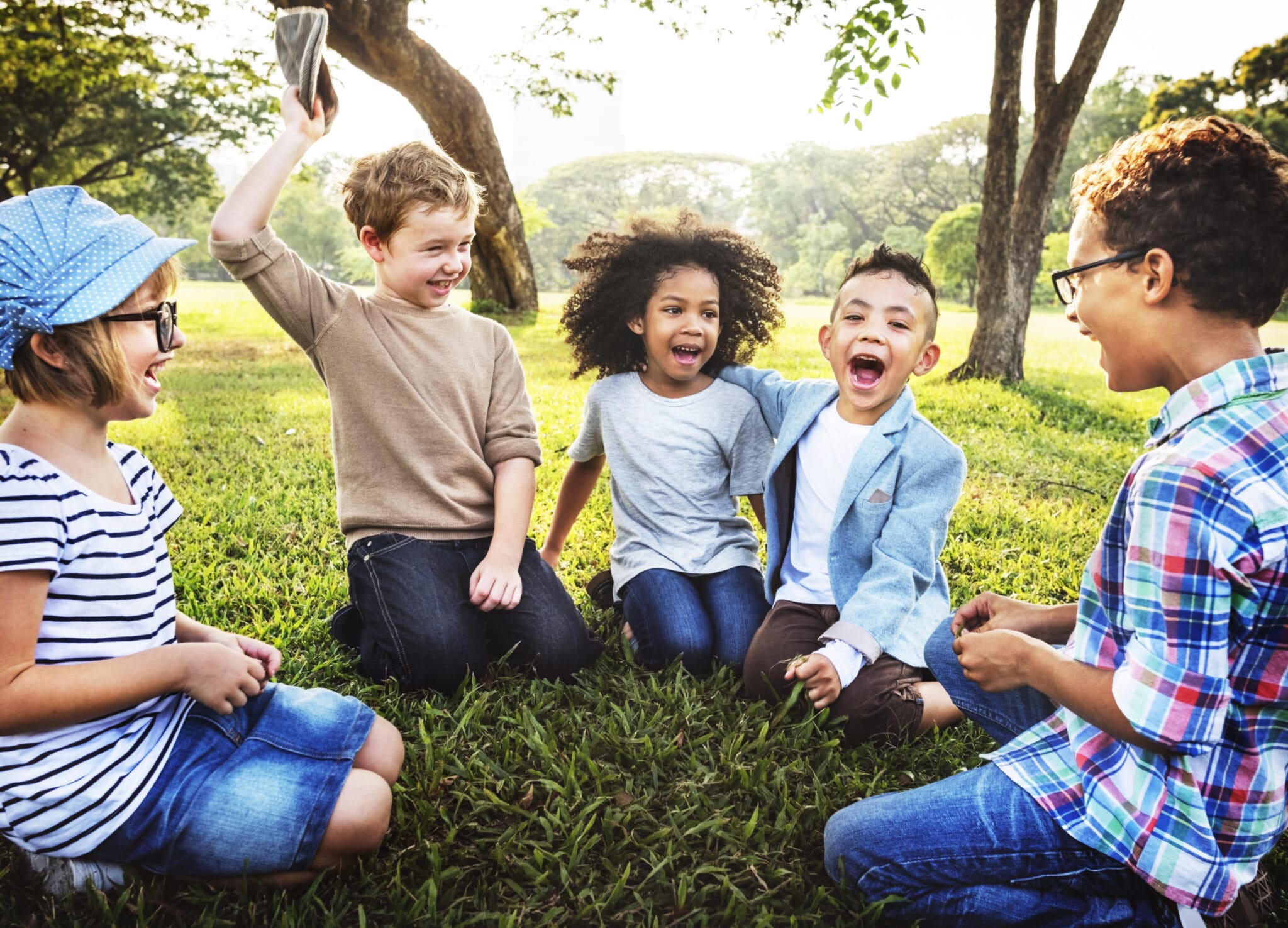 Children are playing on the grass in the park