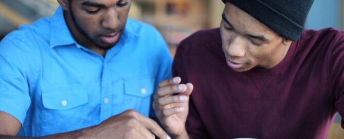 Two young men studying together.