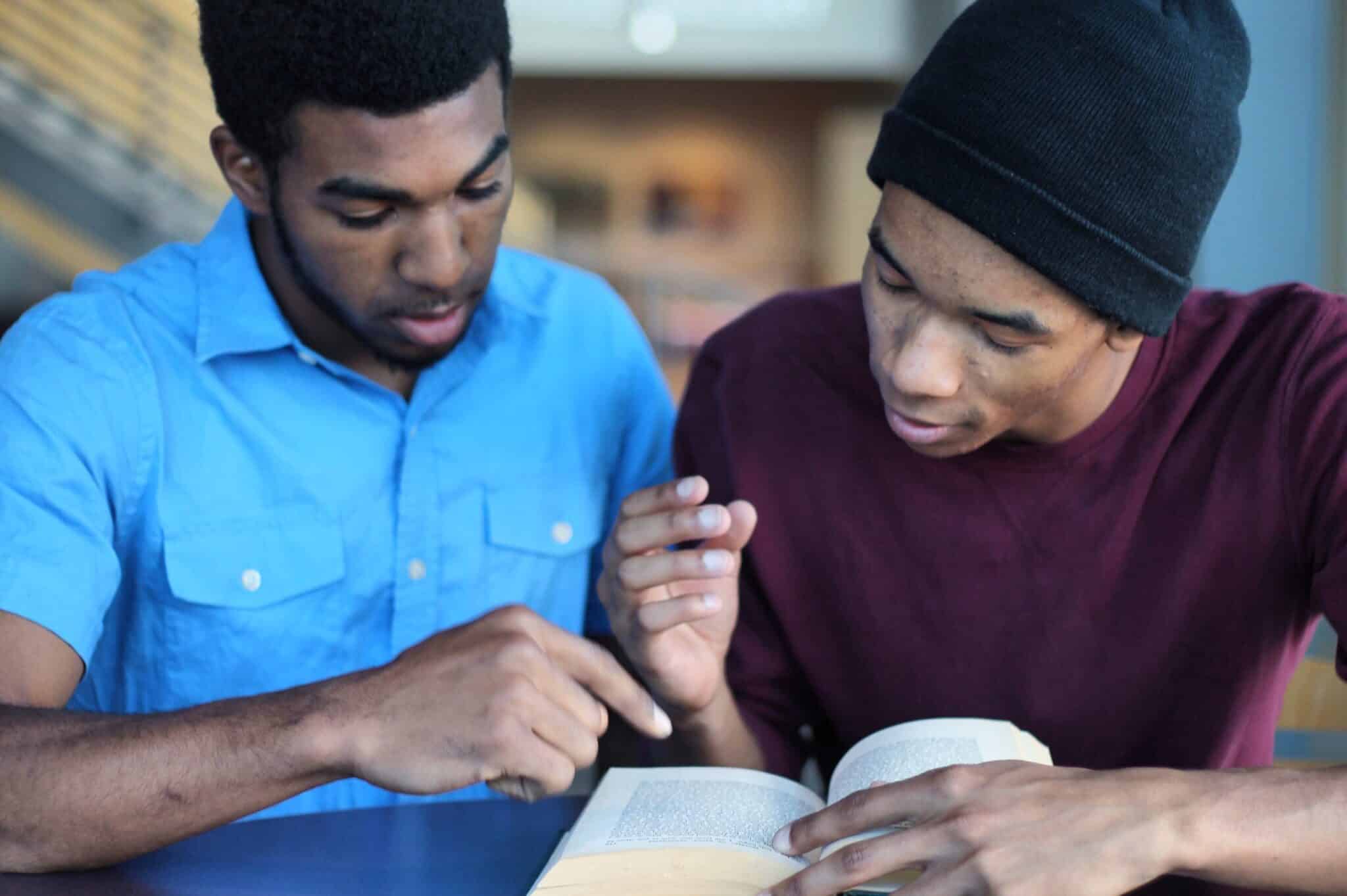Two young men studying together.