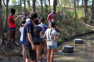 Young people hanging out near a stream