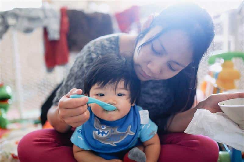 Mother Feeding Child