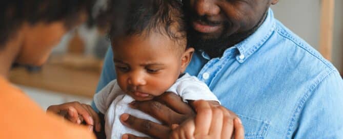 Parents carrying a baby