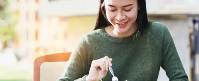 A teen eats a salad