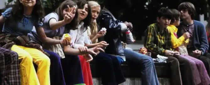 a group of kids eating a snack outside