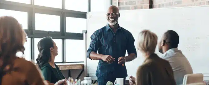 a man presents to a group of his colleagues