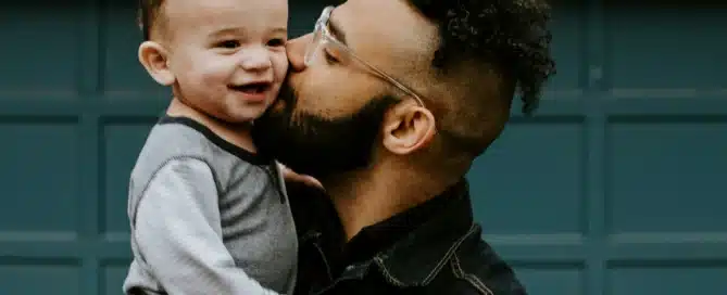 a father holds his son